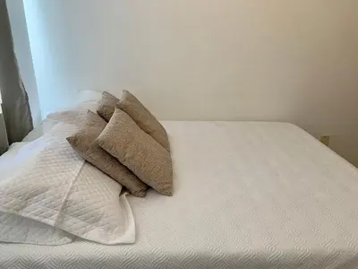 Uma cama ou camas num quarto em Residencial Viapiana - Condomínio no Centro de Bombinhas próximo a praia de 4 Ilhas