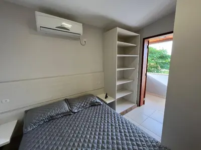 Uma cama ou camas num quarto em cód 4 · Casa com piscina próxima a praia de palmas