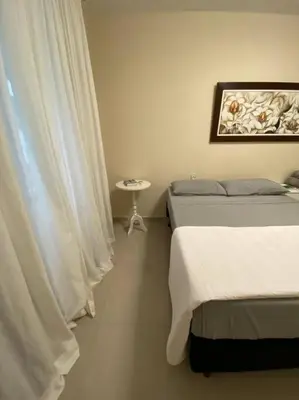 Uma cama ou camas num quarto em Apto Centro Bombinhas
