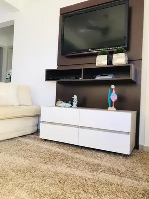 Uma televisão e/ou sistema de entretenimento em Apartamento Praia de Porto Belo, Balneario Pereque, SC