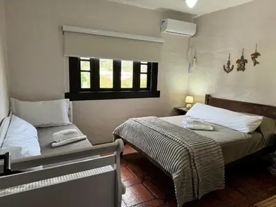 Uma cama ou camas num quarto em Bombinhas
