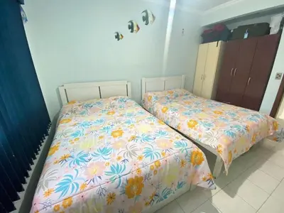 Uma cama ou camas num quarto em Res Palmeiras Bombinhas Centro