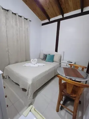 Uma cama ou camas num quarto em Suíte Pachamama