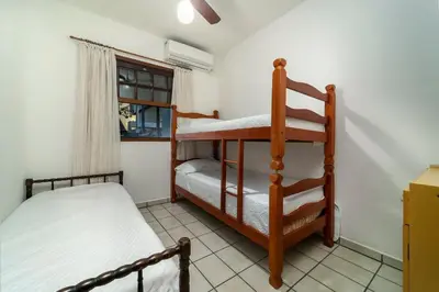 Uma cama ou camas num quarto em Aluguel casa 3 quartos Bombinhas SC