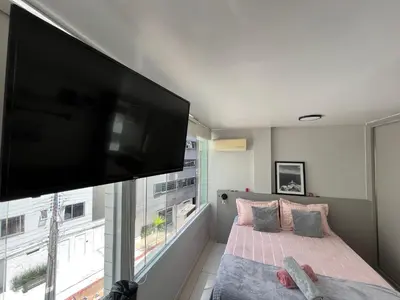 Uma cama ou camas num quarto em Apartamento dos Sonhos - Studio em Prédio a Beira Mar