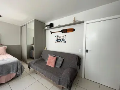 Uma cama ou camas num quarto em Apartamento dos Sonhos - Studio em Prédio a Beira Mar
