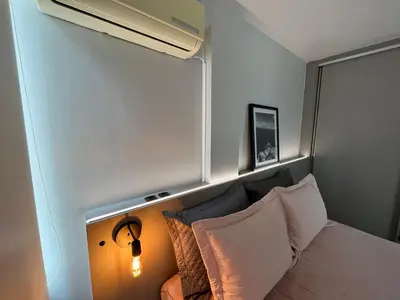 Uma cama ou camas num quarto em Apartamento dos Sonhos - Studio em Prédio a Beira Mar