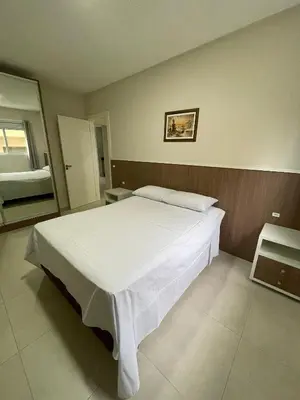 Uma cama ou camas num quarto em Edifício Mario Guilherme em Bombinhas