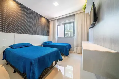 Uma cama ou camas num quarto em Edifício Costa Brava em Canto Grande Bombinhas
