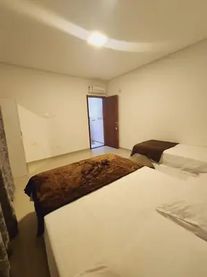 Uma cama ou camas num quarto em Casa Sunstay Garden com piscina