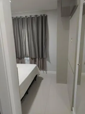 Uma cama ou camas num quarto em Aluguel em Bombinhas