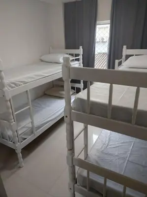 Uma cama ou camas num quarto em Aluguel em Bombinhas