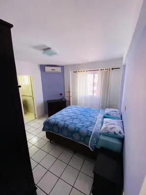 Uma cama ou camas num quarto em APARTAMENTO PRÓXIMO A PRAIA E SHOPPING RUSSI&RUSSI