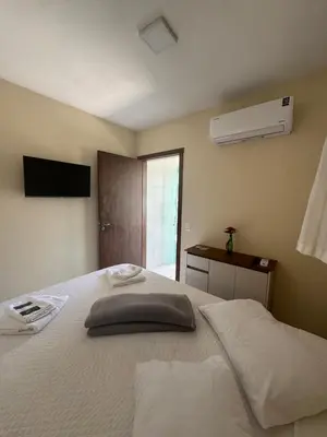 Uma cama ou camas num quarto em residencial Lara 9