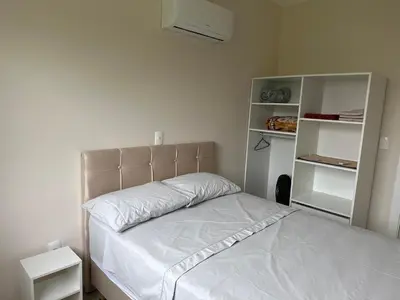 Uma cama ou camas num quarto em Apartamento 2 quartos em Bombinhas