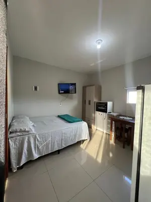 Uma cama ou camas num quarto em Loft no centro de Bombinhas