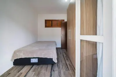 Uma cama ou camas num quarto em Apartamento 3 dormitórios - 50 metros da Praia de Bombinhas