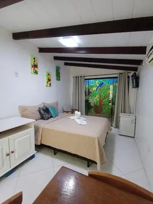 Uma cama ou camas num quarto em Suíte Amazônia