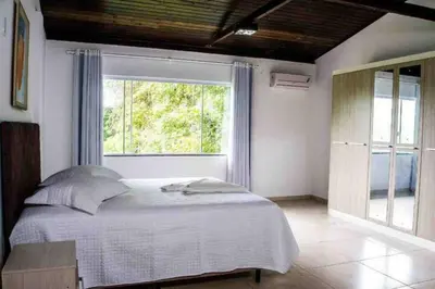 Uma cama ou camas num quarto em Pousada Sabores do Mar Laranjeiras