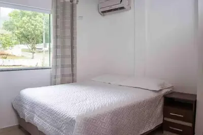 Uma cama ou camas num quarto em Pousada Sabores do Mar Laranjeiras