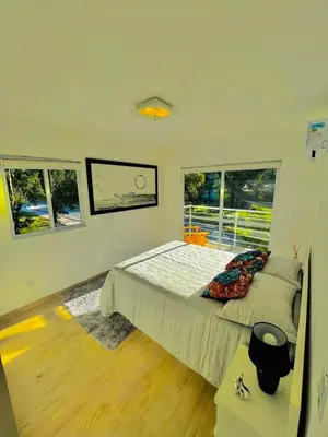 Uma cama ou camas num quarto em Apartamento Beija Flor Bombinhas