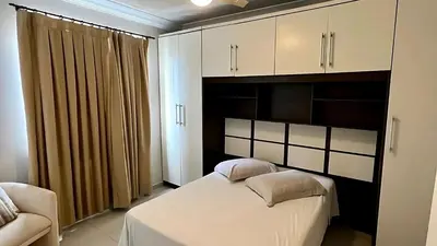 Uma cama ou camas num quarto em Apto Almeida e Moraes Frente Mar Balneário Camboriú