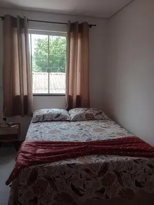Uma cama ou camas num quarto em Linda Casa 2 no Sossego da Praia
