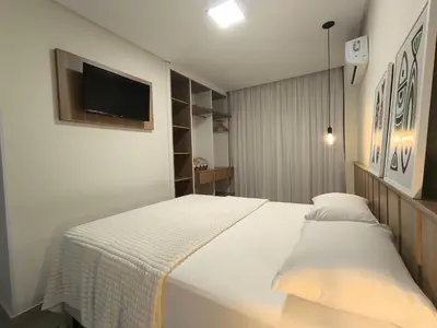 Uma cama ou camas num quarto em Refúgio Praiano em Bombinhas - Aluguel Temporada