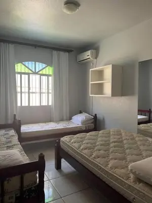 Uma cama ou camas num quarto em Casa mirante com piscina em Governador Celso Ramos