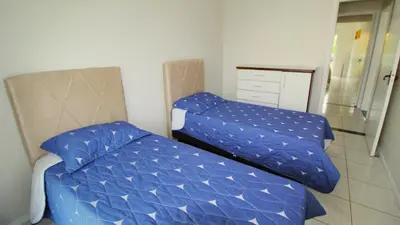 Uma cama ou camas num quarto em 1014 - Apartamento no centro de Bombinhas