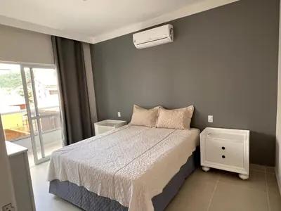 Uma cama ou camas num quarto em Apartamento De Praia em Bombinhas