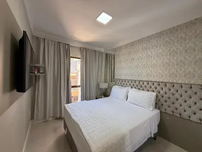 Uma cama ou camas num quarto em Apto totalmente FRENTE MAR, 4 quartos, alto padrão, Itapema
