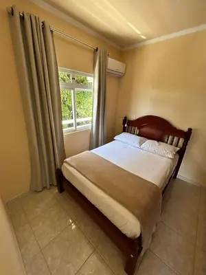 Uma cama ou camas num quarto em Residência Vó Nilton