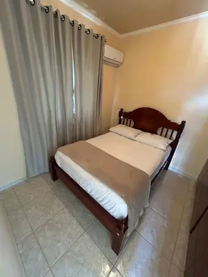 Uma cama ou camas num quarto em Residência Vó Nilton