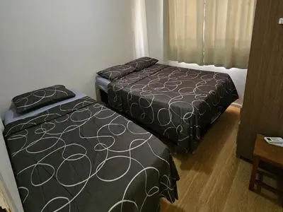 Uma cama ou camas num quarto em Apartamento Beira-mar praia centro itapema