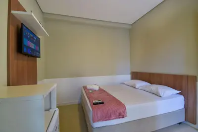 Uma cama ou camas num quarto em Mar de Bombinhas - Centro