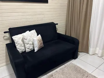 Uma área de estar em Casa aconchegante em Governador Celso Ramos - Nazário