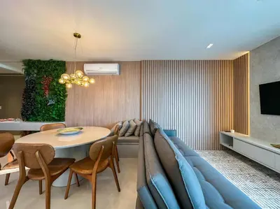 Uma área de estar em Apartamento Novo Quadra Mar