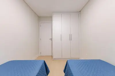 Uma cama ou camas num quarto em Boulevard - Apartamento Pertinho da Praia