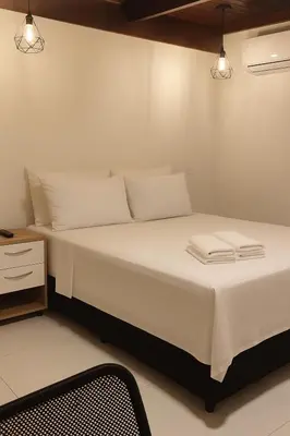 Uma cama ou camas num quarto em Hotel Pousada Litorânea
