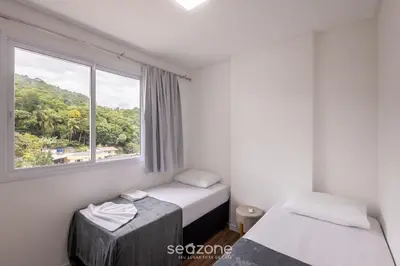 Uma cama ou camas num quarto em Apto Vista Mar c/ churrasq. em Itapema SBN0705