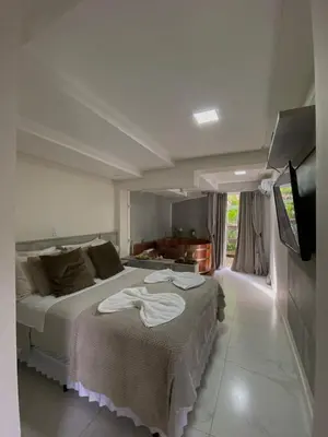 Uma cama ou camas num quarto em Bombinhas Guest House