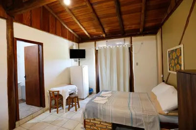 Uma cama ou camas num quarto em Pousada Martin Pescador Bombinhas
