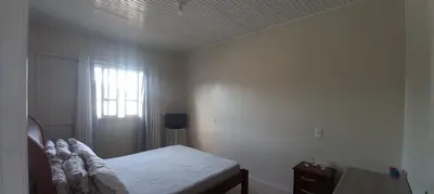 Uma cama ou camas num quarto em Casa com piscina A 250 METROS DA PRAIA de Canto Grande BOMBINHAS