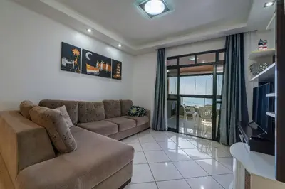 Uma área de estar em A08 - Laélia Purpurata - Apartamento frente mar 03 dormitórios
