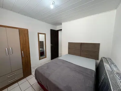 Uma cama ou camas num quarto em A86 - Casa 02 dormitórios no centro.