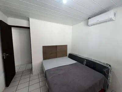Uma cama ou camas num quarto em A86 - Casa 02 dormitórios no centro.