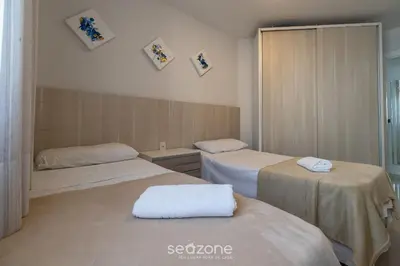 Uma cama ou camas num quarto em RFO - Apartamentos a poucos passos da Praia de Bombinhas