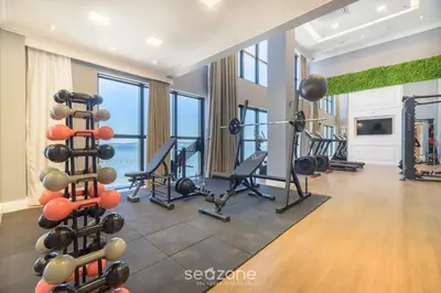 O centro de fitness e/ou as comodidades de fitness de MHFBs - Edifício Moderno c/ piscina vista mar em Itapema