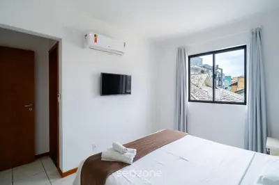 Uma cama ou camas num quarto em Apto 3Q c/ churrasq. 240m do mar Bombas/SC CAY0123